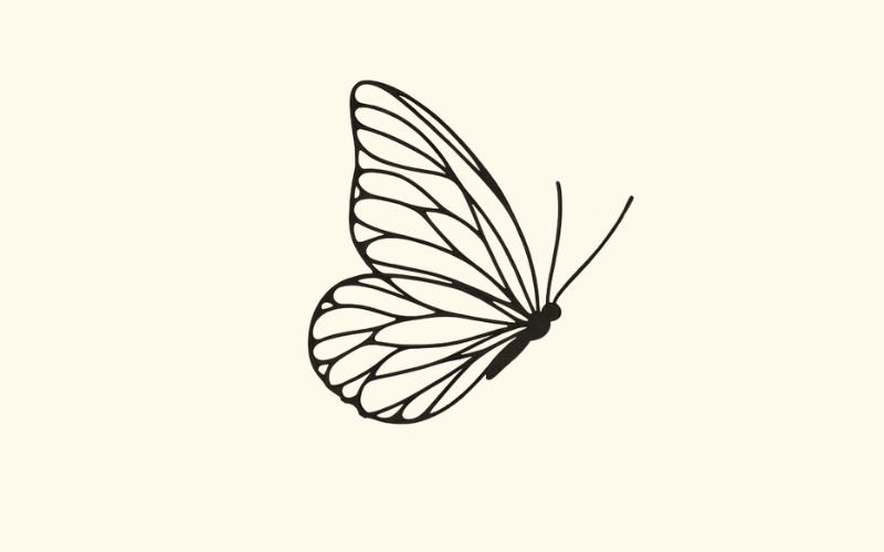 A black minimalist butterfly tattoo wrist tattoo.